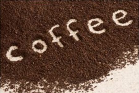 the word coffee written in coffee grounds